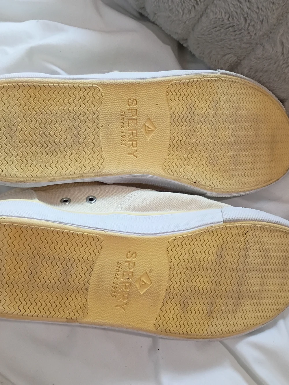 Yellow-tinged cream canvas sneakers are the Sperry Striper II CVO low-tops Sz 10